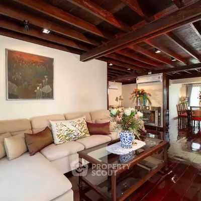 Charming living room with wooden beams and elegant decor in a cozy home setting.
