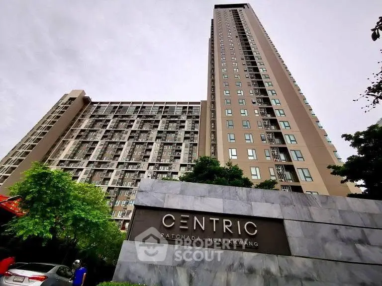 Modern high-rise condominium Centric Ratchada Huai Khwang with lush greenery and urban appeal.