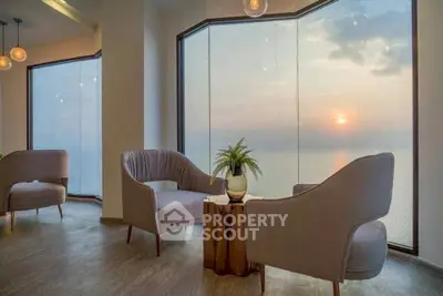 Luxurious living room with panoramic ocean view and elegant seating area.