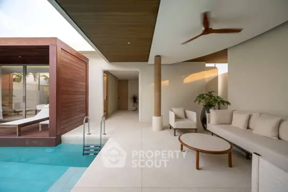 Luxurious modern poolside patio with elegant seating and sleek design.