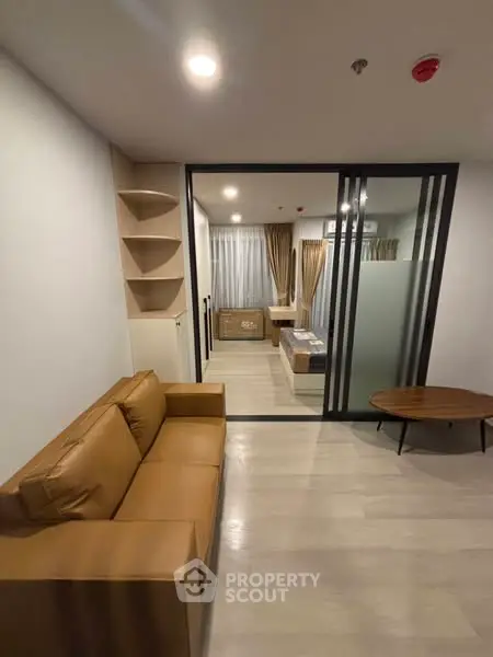 Modern living room with glass partition and stylish furniture