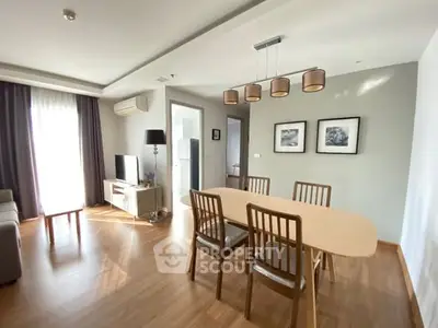 Spacious living room with modern dining area and natural light.
