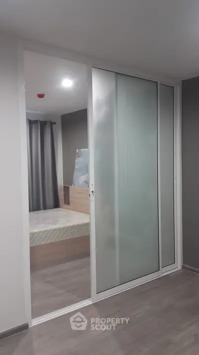 Modern bedroom with sliding glass door and stylish decor