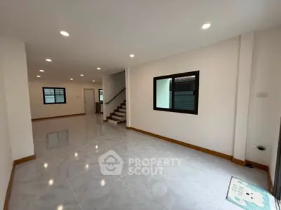 Spacious modern living room with sleek tile flooring and recessed lighting