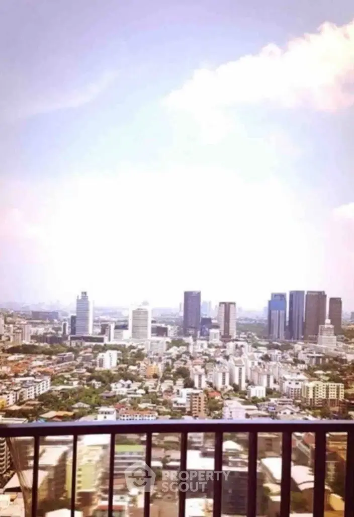 Stunning cityscape view from a high-rise balcony, showcasing urban skyline and vibrant city life.