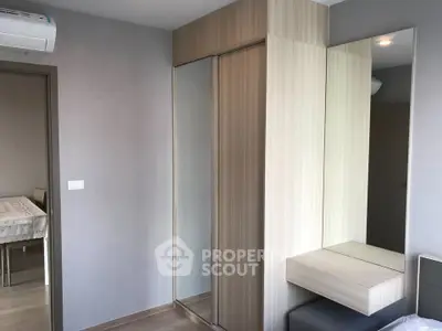 Modern bedroom with mirrored wardrobe and sleek wooden furniture