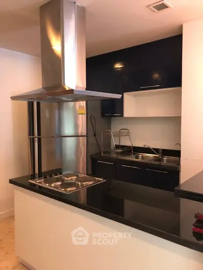 Modern kitchen with sleek black countertops and stainless steel appliances