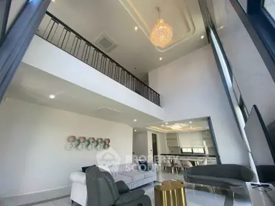 Luxurious modern living room with high ceilings and elegant chandelier