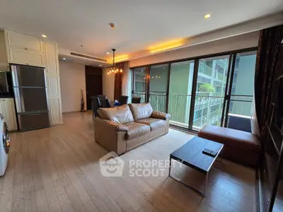 Spacious living room with modern furniture and large windows offering natural light.