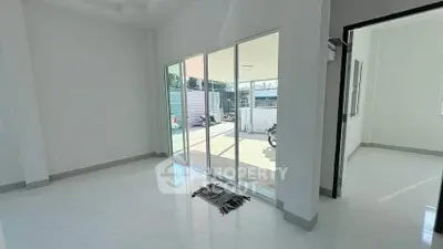 Bright living room with sliding glass doors leading to a spacious patio area.
