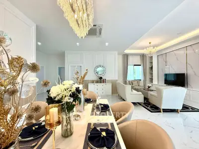 Luxurious open-plan living and dining area with elegant decor and chandeliers