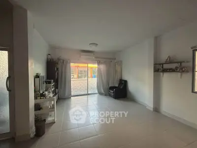 Spacious living room with large windows and minimalist decor