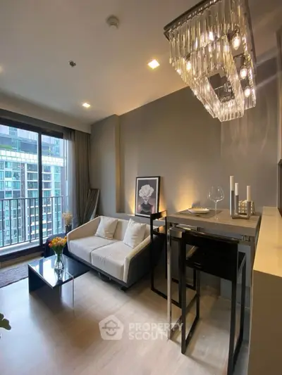 Modern living room with elegant chandelier and city view balcony