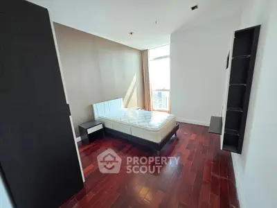 Spacious bedroom with modern design and hardwood floors