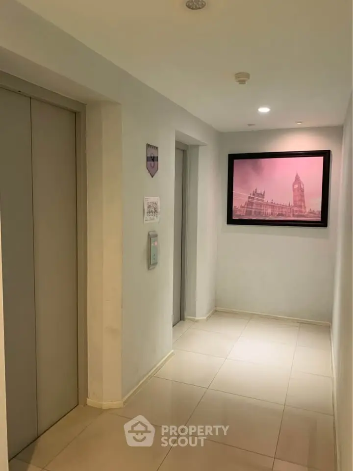 Modern building elevator lobby with stylish artwork and sleek design.
