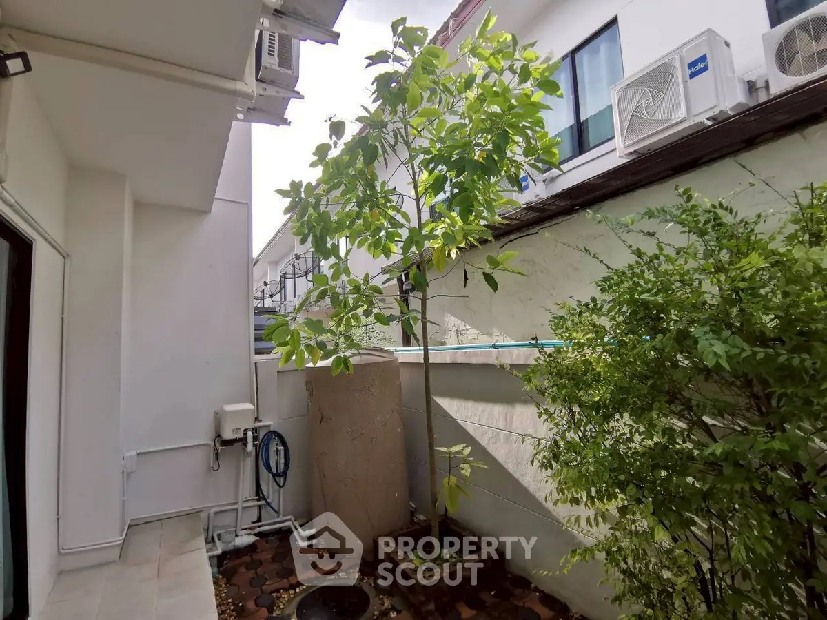 Charming garden area with lush greenery and modern exterior design.