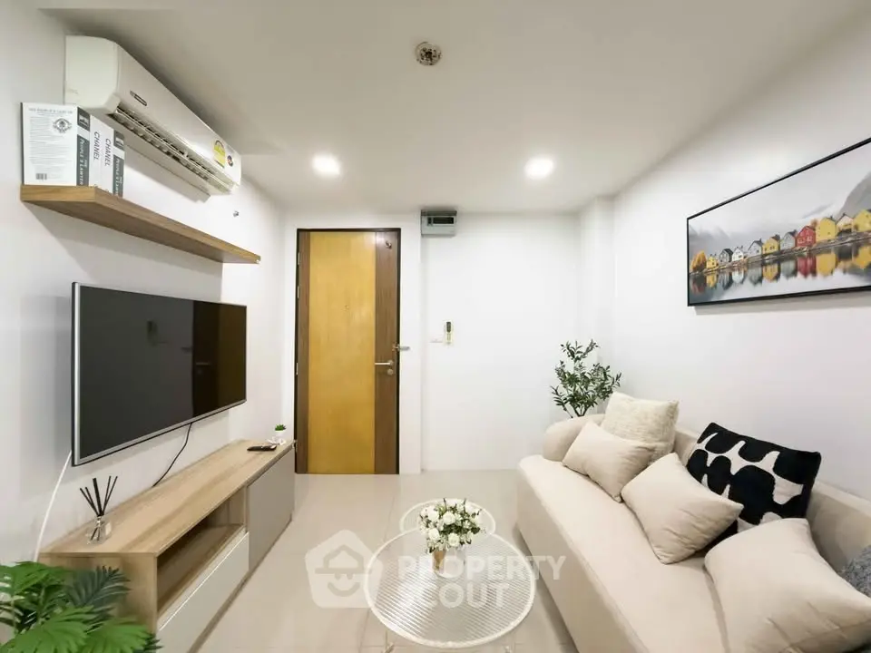 Modern living room with cozy sofa and wall-mounted TV in stylish apartment