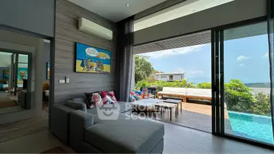 Luxurious living room with pool and ocean view, modern decor, and spacious seating area.