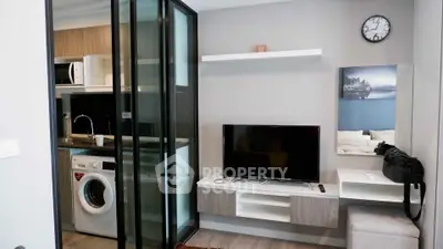 Modern living room with open kitchen and washing machine in stylish apartment