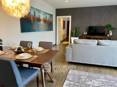 Modern living room with stylish dining area and cozy seating, featuring elegant decor and warm lighting.
