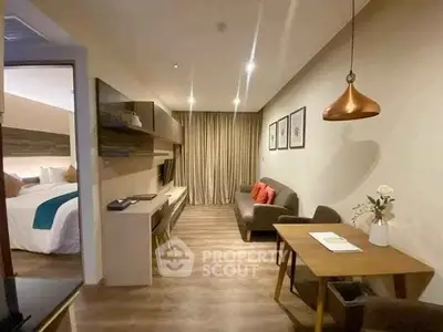Modern living room with stylish decor and open layout leading to a cozy bedroom.