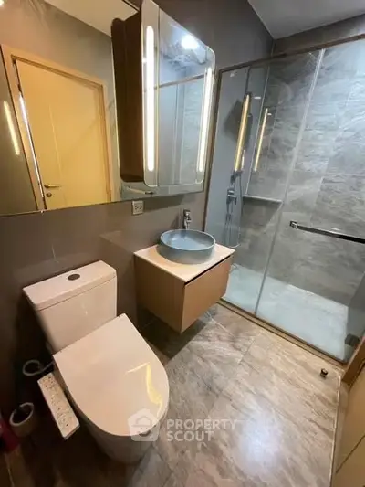 Modern bathroom with sleek fixtures and glass shower enclosure