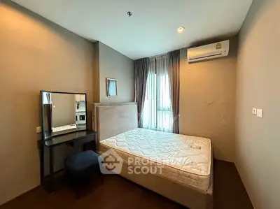 Modern bedroom with natural light, featuring a comfortable bed and stylish decor.