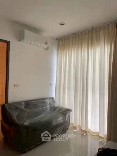 Cozy small living room with air conditioning and natural light