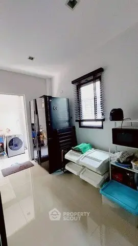 Spacious storage room with sleek black cabinet and organized shelving
