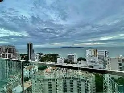 Stunning high-rise ocean view from a modern city apartment balcony.