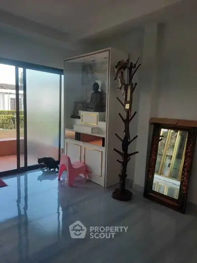Spacious living room with modern decor and large windows for natural light.
