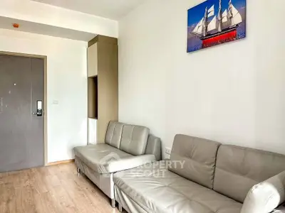 Modern living room with sleek sofas and nautical wall art