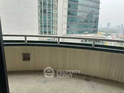 Spacious balcony with city view in modern high-rise building