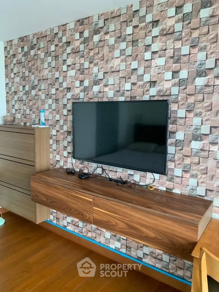 Modern living room with stylish TV setup and textured wall design