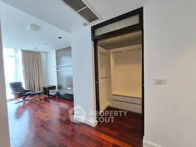 Spacious modern living room with walk-in closet and elegant wooden flooring