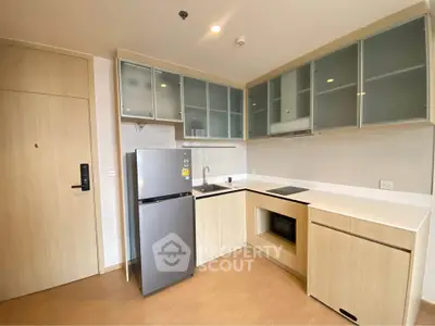 Modern kitchen with sleek cabinetry and built-in appliances in a stylish apartment.
