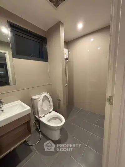 Modern bathroom with sleek design and shower area in contemporary apartment.