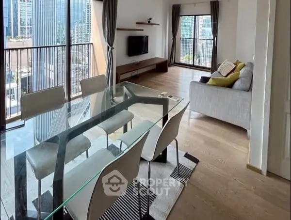Spacious modern living room with glass dining table and city view