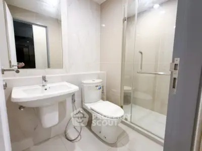 Modern bathroom with sleek fixtures and glass shower enclosure