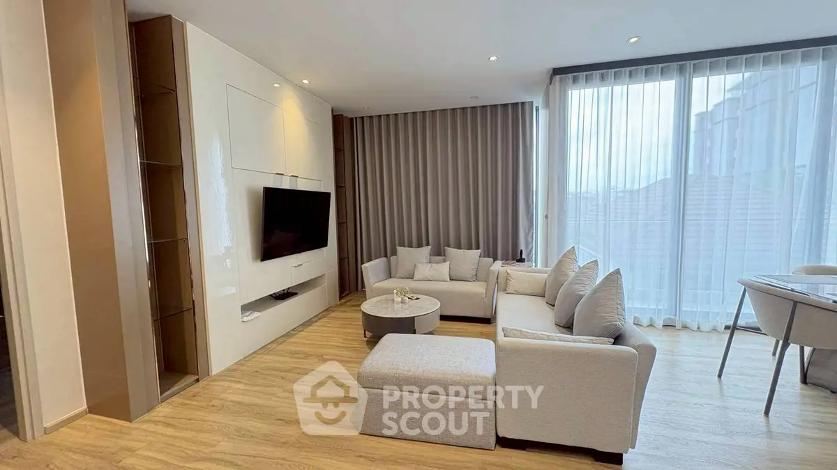 Spacious modern living room with large windows and elegant decor