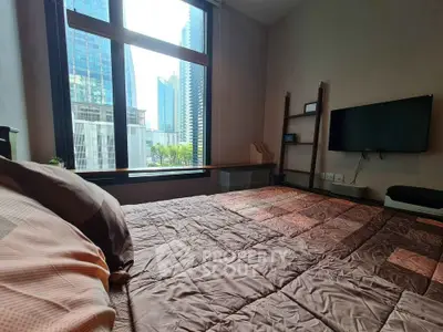 Modern bedroom with city view and wall-mounted TV in high-rise apartment