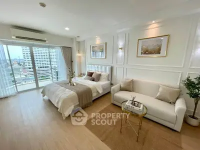 Luxurious bedroom with elegant decor and city view balcony in modern apartment.