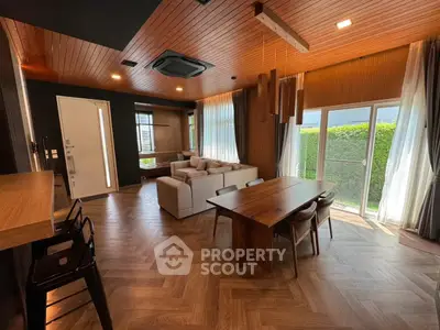 Spacious modern living room with wooden accents and large windows