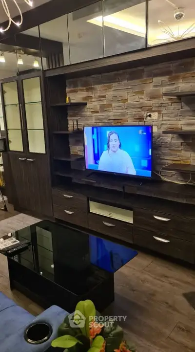 Modern living room with stylish dark wood entertainment center and mounted TV