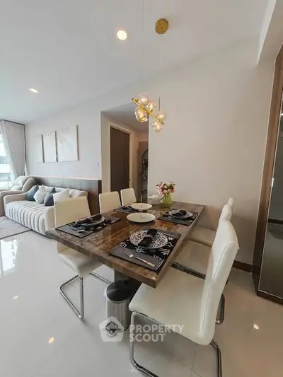 Modern dining area with elegant table setting and stylish lighting in a contemporary apartment.