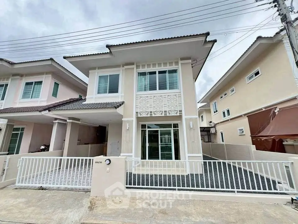 Modern two-story house with gated driveway and stylish facade