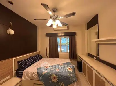 Cozy bedroom with modern ceiling fan and stylish decor