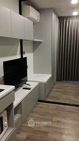 Modern living room with sleek furniture and wooden flooring