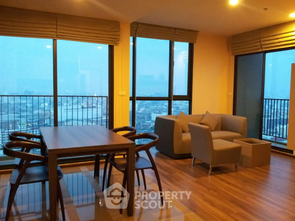 Spacious living room with panoramic city view and modern furniture