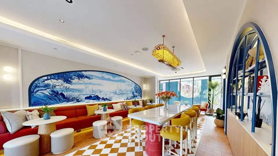 Stylish modern living room with vibrant decor and large windows for natural light.